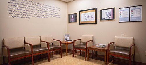 a line of chairs and artwork on the walls